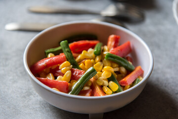 Boiled vegetables beans, carrots and corn in a bowl with use of selective focus.