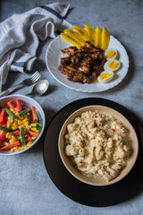 Continental delicacy vegetable cheese augratin, chicken wings and boiled vegetables on a background. 