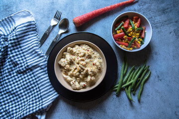 Popular dish vegetable cheese augratin and boiled vegetables. Top view, selective focus.