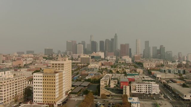 Wildfire smoke covers Los Angeles downtown skyline MacArthur Park aerial shot 2020 September Pan Right