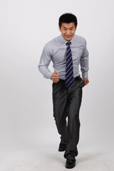 A business man jumping up in a shirt 