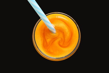Glass of fruit juice with added gold glitter