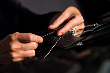 A leather craftsman works with leather. Sews leather goods. Use needle and thread for sewing. ...