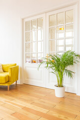 Scandinavian style apartment interior. bright yellow warm colors. wooden flooring. sunlight in large windows.