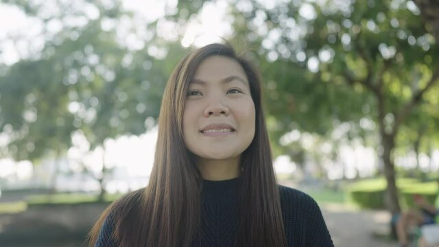 beautiful happy asian woman smilng in the park