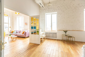 Fototapeta na wymiar very light and sparcious two-rooms apartment in scandinavian design style with fashion furniture and large windows. warm colors during day time