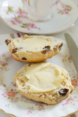 Scones a classic British cake filled with sultanas and raisins and often served buttered during afternoon tea