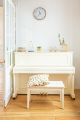 the interior of the study in the style of a loft. Brick wall. wooden flooring. large bright room with a seating area. sofa and piano