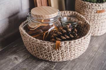 Eco friendly jute knitted baskets with decor, candle. Zero waste concept. Decor and interior