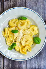 Home made vegetarian  italian  bio  egg  fresh   tortelloni pasta   for cheese garnished  with olive oil    and parmesan cheese