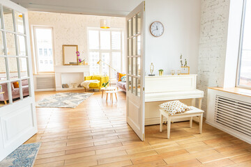 very light and sparcious two-rooms apartment in scandinavian design style with fashion furniture and large windows. warm colors during day time