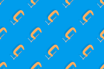 Clamp seamless pattern. Pattern of metal clamp on a blue background.