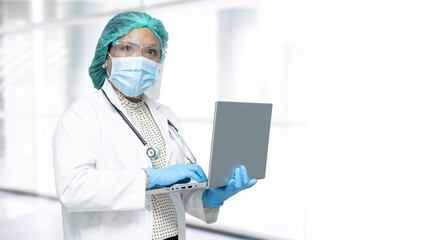 Asian doctor wearing face shield and PPE suit new normal to check patient protect safety infection Covid-19 Coronavirus outbreak at quarantine nursing hospital ward.