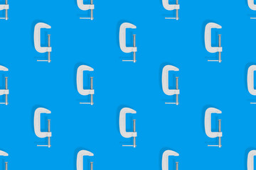 Clamp seamless pattern. Pattern of metal clamp on a blue background.