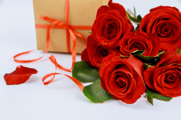 Gift and beautiful red roses on white background. Valentines Day.