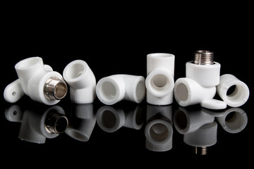 plumbing fittings for plastic pvc pipes on black background