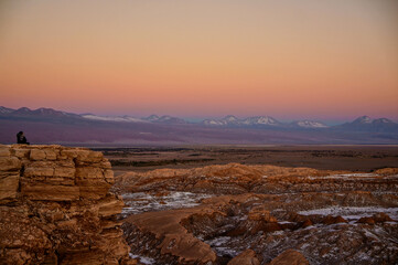 Woman admiring the sunset view of the Moon Valley in the Atacama Desert, Antofagasta, Chile