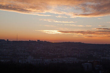 Dramatic sunset with dark cityscape and sky