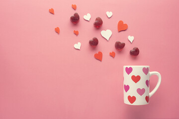 gummy and paper hearts, cup on pink background