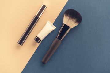cosmetic accessories on a colored background top view