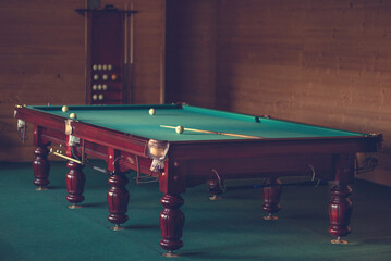 billiards table with balls and cue