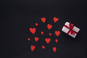 red  paper hearts against a dark background