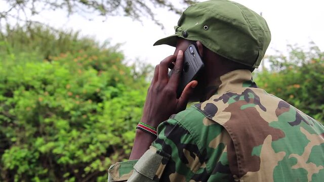 African guerilla militant soldier talking on cellphone