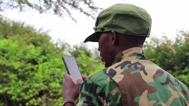 African militant guerilla using his cellphone