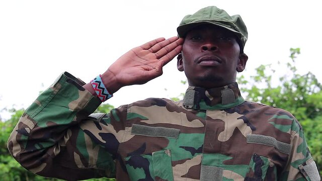 African soldier guerilla standing in salute pose