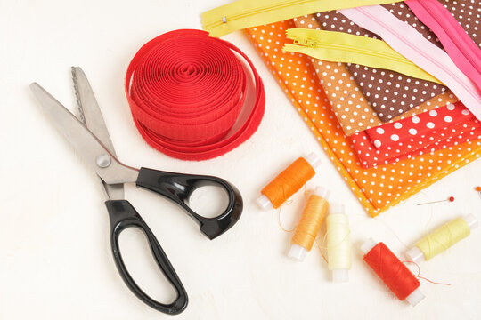 Spools Of Thread, Fabrics, Zipper And Velcro Tape On The Table, Accessories For Sewing Concept