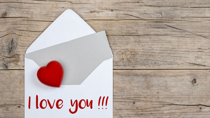 Valentines day love wedding greeting card concept banner. Envelope, card with text, I love you !!! and key with red heart on rustic wooden wood table texture background top view. Flat lay.