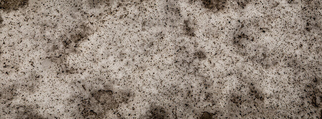 Badly stained texture on the snowy road 
