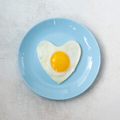 Heart shaped omelette on a light blue plate