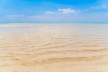 Fototapeta na wymiar sand beach and blue sky, background, blurred