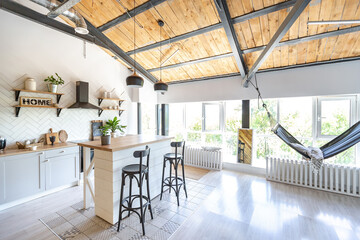 stylish kitchen interior design. white walls and wooden decoration. beautiful hammock and high windows.