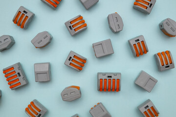 the terminal clamps for connection of wires. the terminal clips are evenly distributed over the surface of the blue background