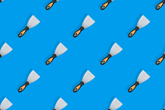 Putty trowel seamless pattern. Spatulas for a blue background.