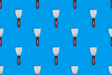 Putty trowel seamless pattern. Spatulas for a blue background.