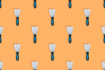 Putty trowel seamless pattern. Spatulas for on an orange background.