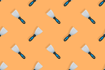 Putty trowel seamless pattern. Spatulas for on an orange background.