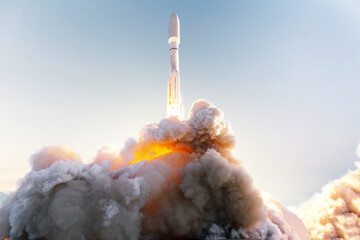 Space rocket takes off into space with clouds of smoke and fire against the clear blue sky....