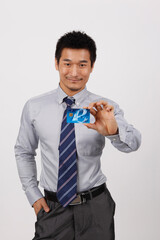 A young business man with a bank card
