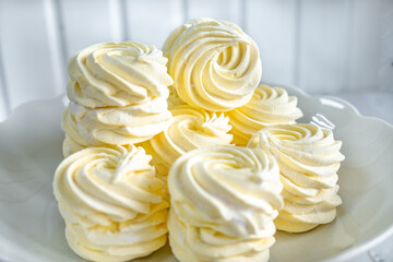 yellow marshmallow on a white stand. handmade dessert from mango, passion fruit