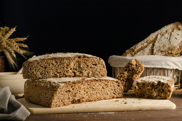 Cut freshly baked whole grain rye bread with copy space, homemade baked goods.