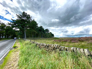 Fototapeta premium Moor top view, next to, Otley Road, with heavy clouds above near, Bingley, Bradford, UK