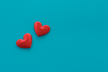 Two red hearts on blue background. Love and passion minimal concept. Flatlay, copy space.