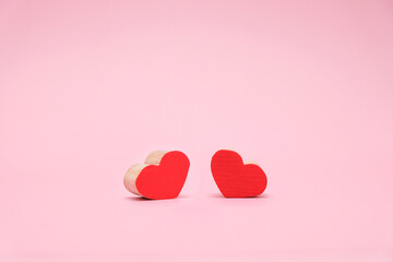 Valentines Day background with red wood heart on pink background. February 14 greeting card 