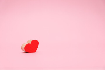 Valentines Day background with red wood heart on pink background. February 14 greeting card 