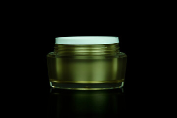 Fototapeta na wymiar Mockup empty luxury golden cream jar for skincare and beauty skin is uncover, isolated on black background with clipping path.