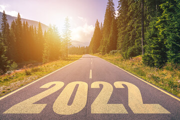 Empty asphalt road and New year 2022 concept. Driving on an empty road in the mountains to upcoming...